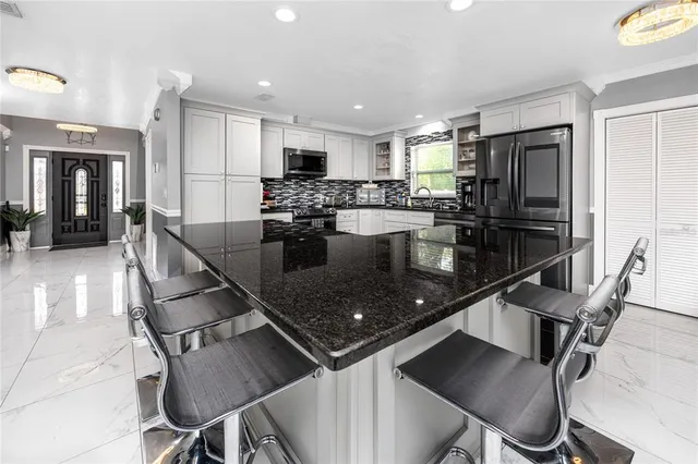 a kitchen with a refrigerator and a sink