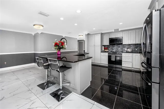 a kitchen with granite countertop a sink and a stove