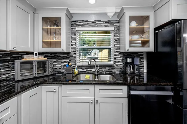 a bedroom with a bed a couch and a chandelier