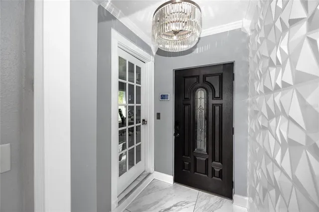 a bedroom with a bed and a chandelier