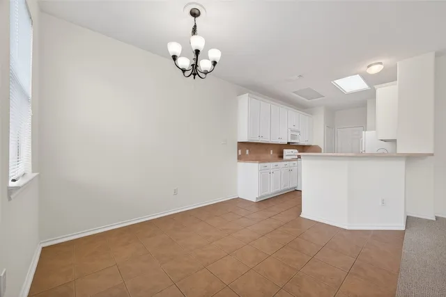 a view of kitchen with center island and stainless steel appliances