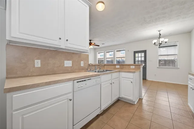 a kitchen with granite countertop white cabinets and white appliances