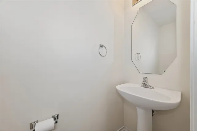 a bathroom with a sink and mirror