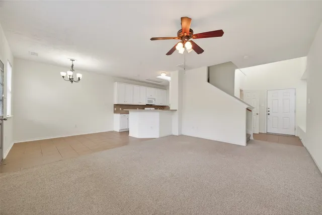 a view of a kitchen with a ceiling fan and a ceiling fan