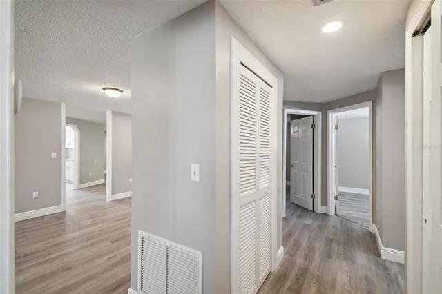 a view of hallway with wooden floor