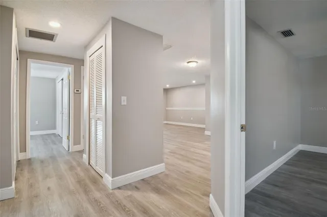 a view of a hallway with wooden floor