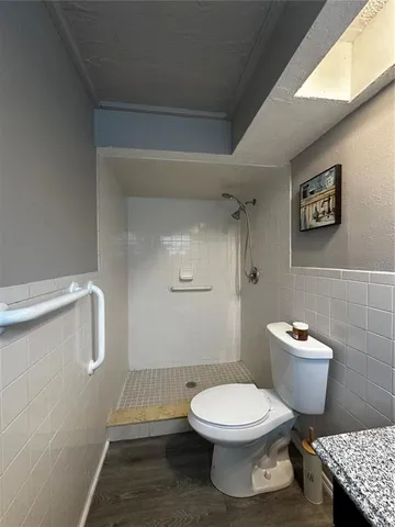 a white toilet sitting next to a bathroom sink