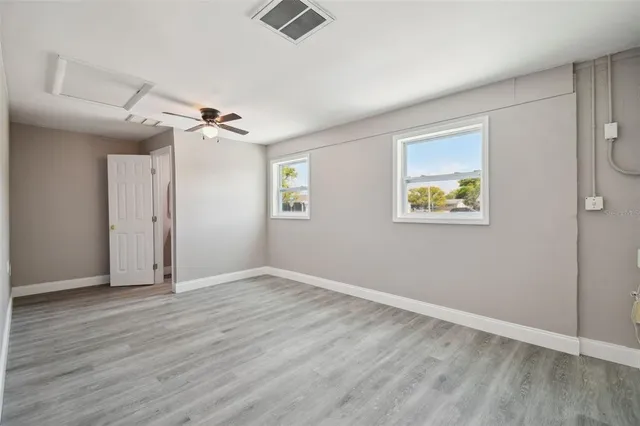 wooden floor in an empty room with a window