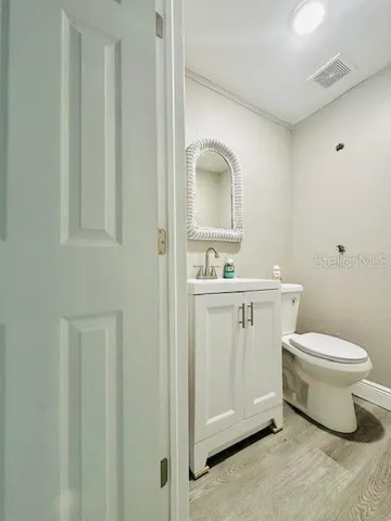 a bathroom with a toilet sink and mirror