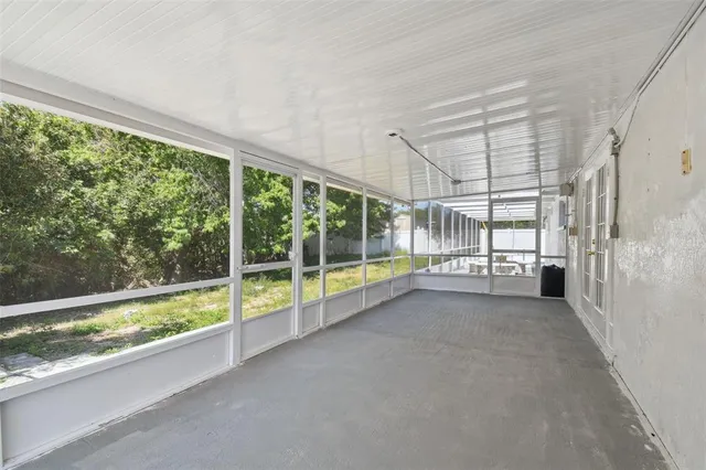 a view of an empty room with windows