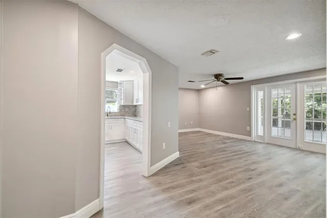 a view of an empty room with glass door
