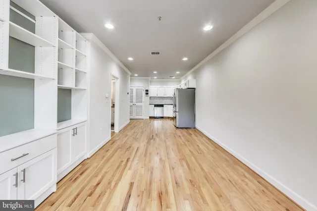 a view of kitchen with cabinets and wooden floor