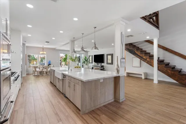 a living room with furniture a rug and a chandelier