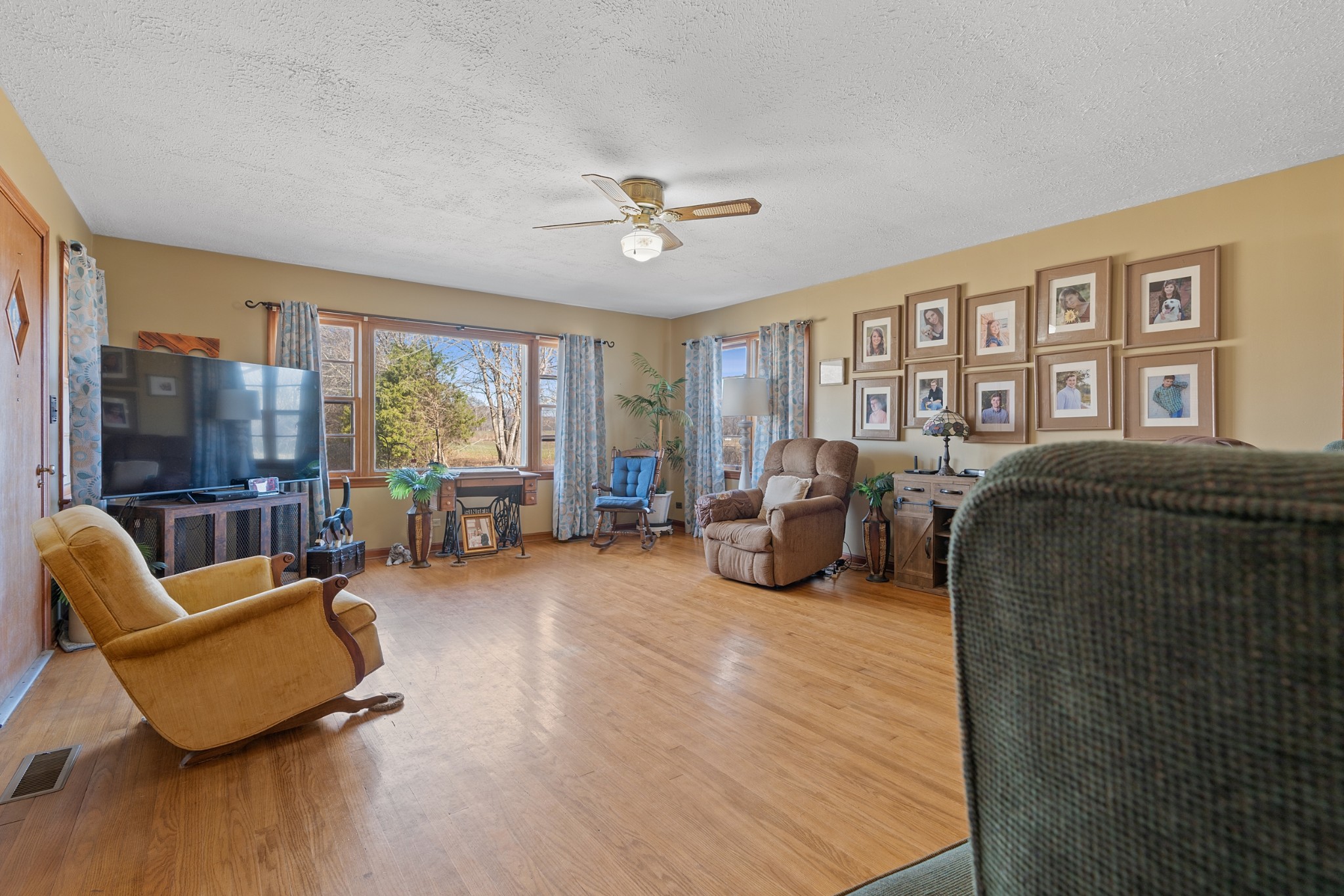 336 Martin-Childers Road New Hope, AL 35760 - Photo 6 of 28 a living room with furniture ceiling fan and a floor to ceiling window