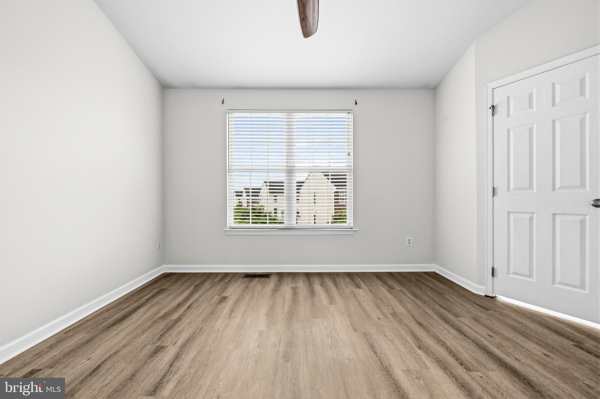 25154 Monteith Terrace Chantilly, VA 20152 - Photo 15 of 40 an empty room with wooden floor and windows