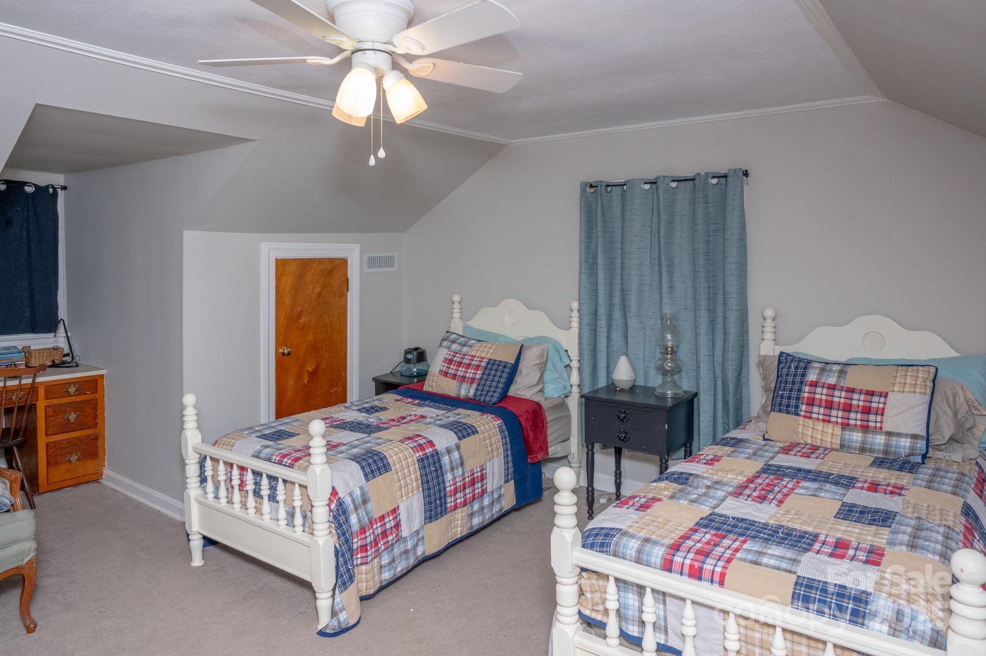 109 Old Rockwell Road China Grove, NC 28023 - Photo 15 of 22 a bedroom with a bed and a chandelier