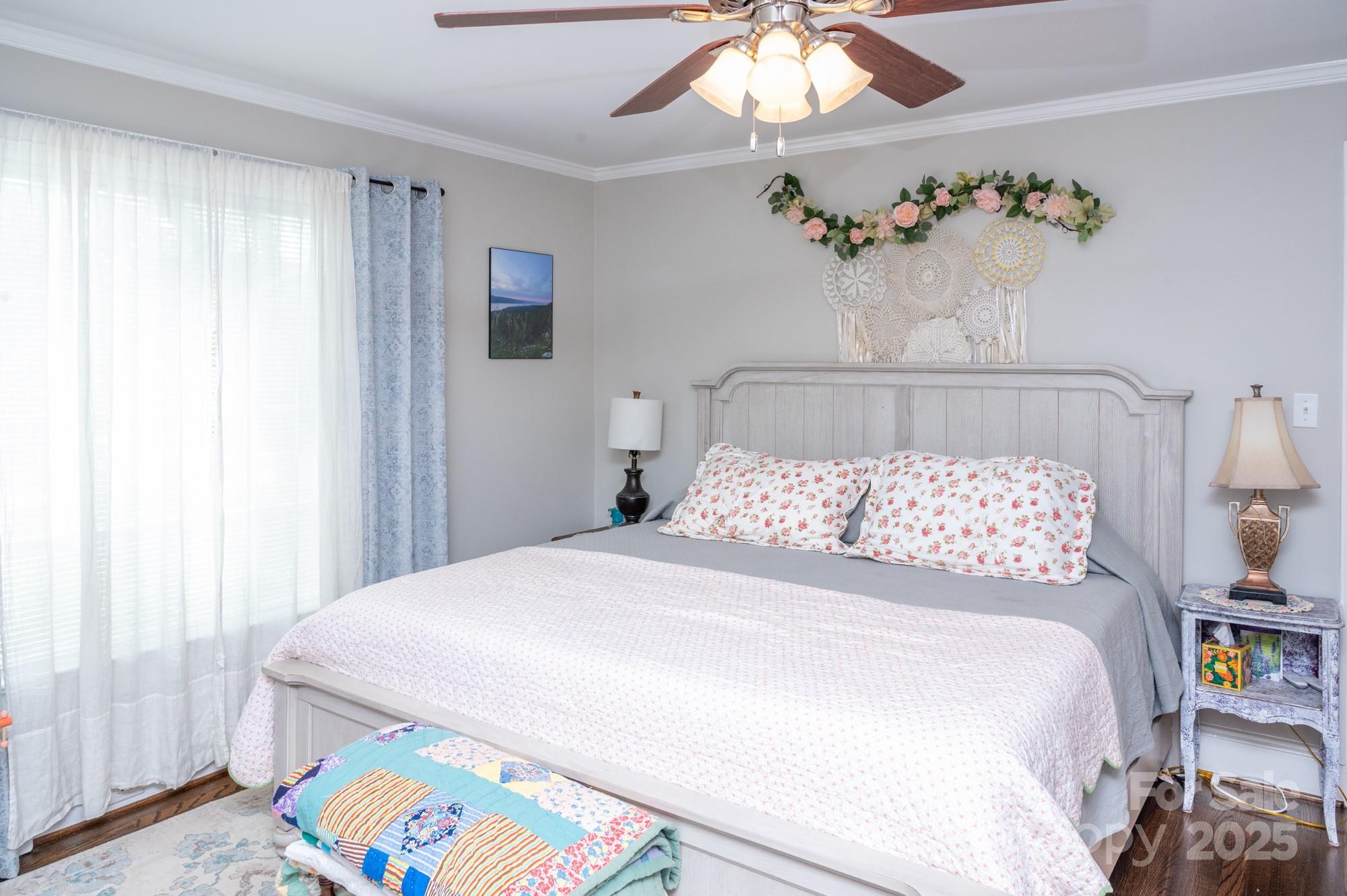 109 Old Rockwell Road China Grove, NC 28023 - Photo 10 of 22 a bedroom with a bed and a chandelier