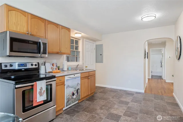 a kitchen with stainless steel appliances a stove a sink and a microwave