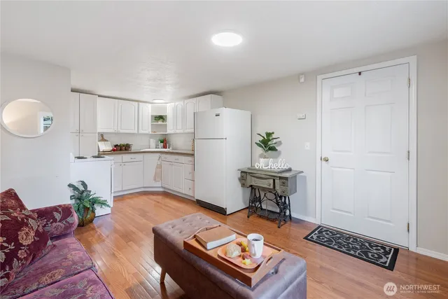 a living room with furniture and wooden floor