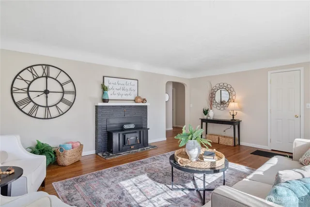 a living room with furniture a window and a fireplace