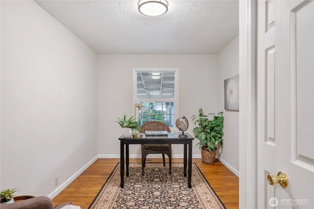 a workspace room with furniture and wooden floor
