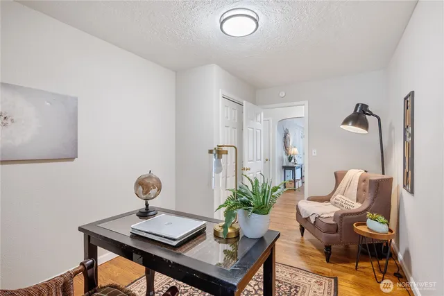 a view of a workspace room with furniture and mirror