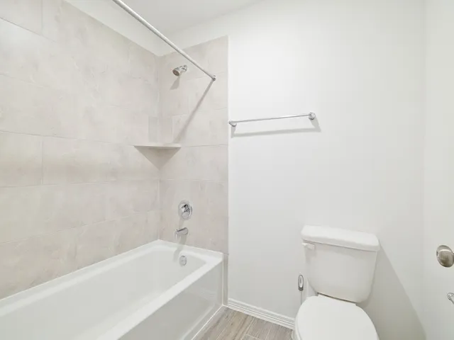 a bathroom with a toilet and a bathtub