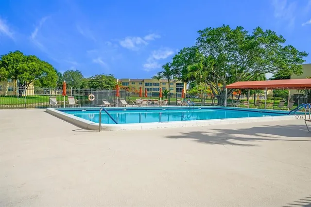 a view of a swimming pool and a yard
