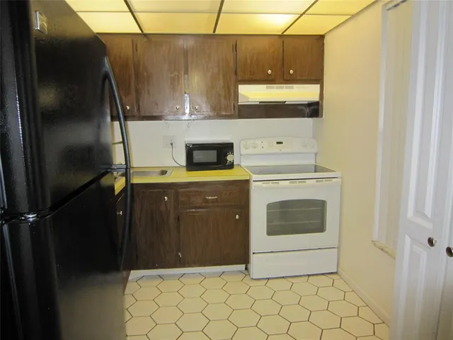 a kitchen with a stove and a refrigerator
