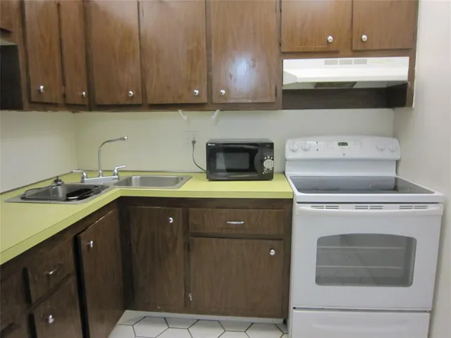 a kitchen with a sink cabinets and appliances