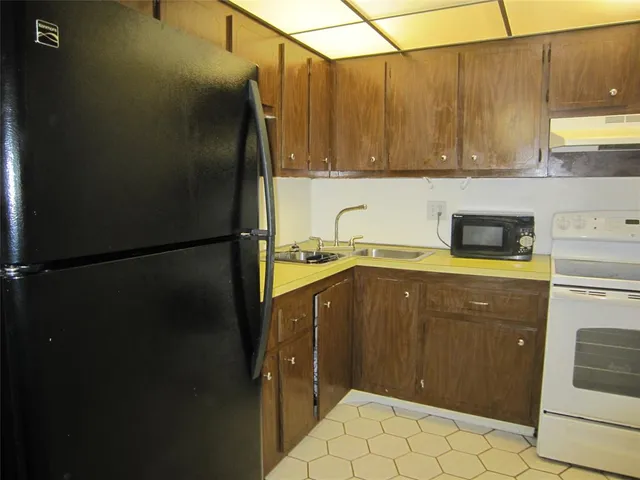 a kitchen with a refrigerator and cabinets