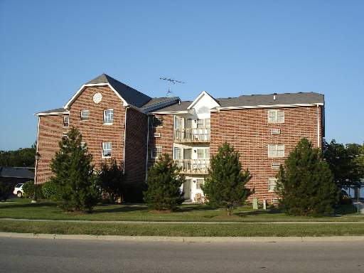 431 Leah Lane, Unit 3C Woodstock, IL 60098 - Photo 1 of 1 a front view of a house with a garden