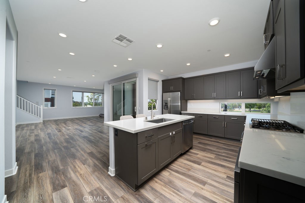 430 Transport Tustin, CA 92782 - Photo 20 of 37 a kitchen with stainless steel appliances granite countertop a sink a stove and a wooden floors
