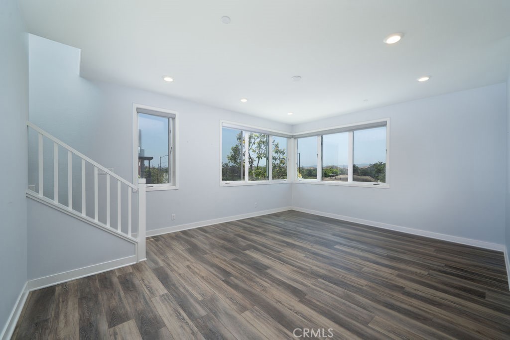 430 Transport Tustin, CA 92782 - Photo 28 of 37 a view of an empty room with wooden floor and a window