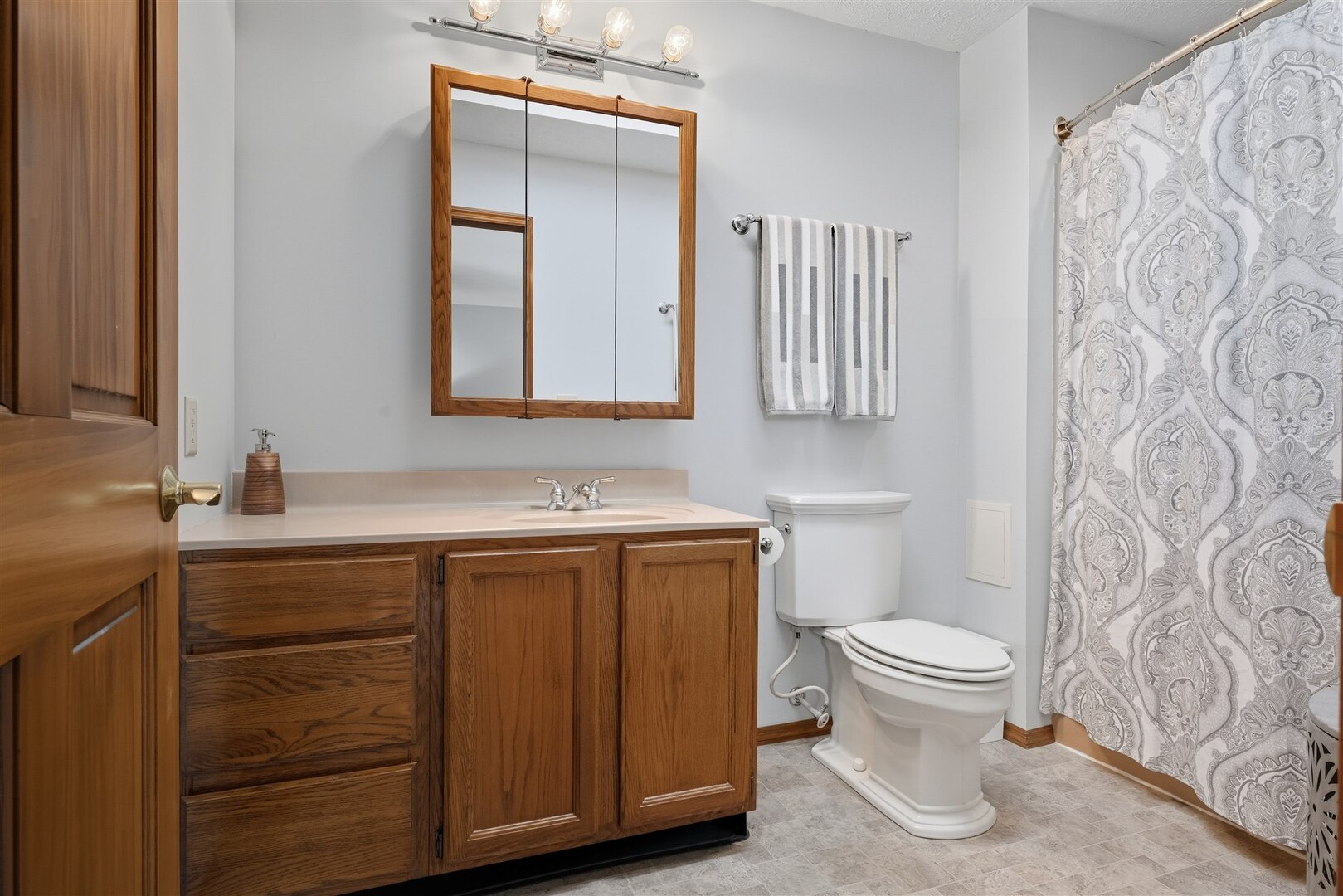 315 Garden Road Normal, IL 61761 - Photo 12 of 32 a bathroom with a toilet sink and mirror