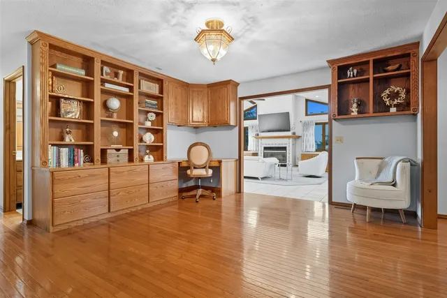 a living room with furniture and a painting on the wall