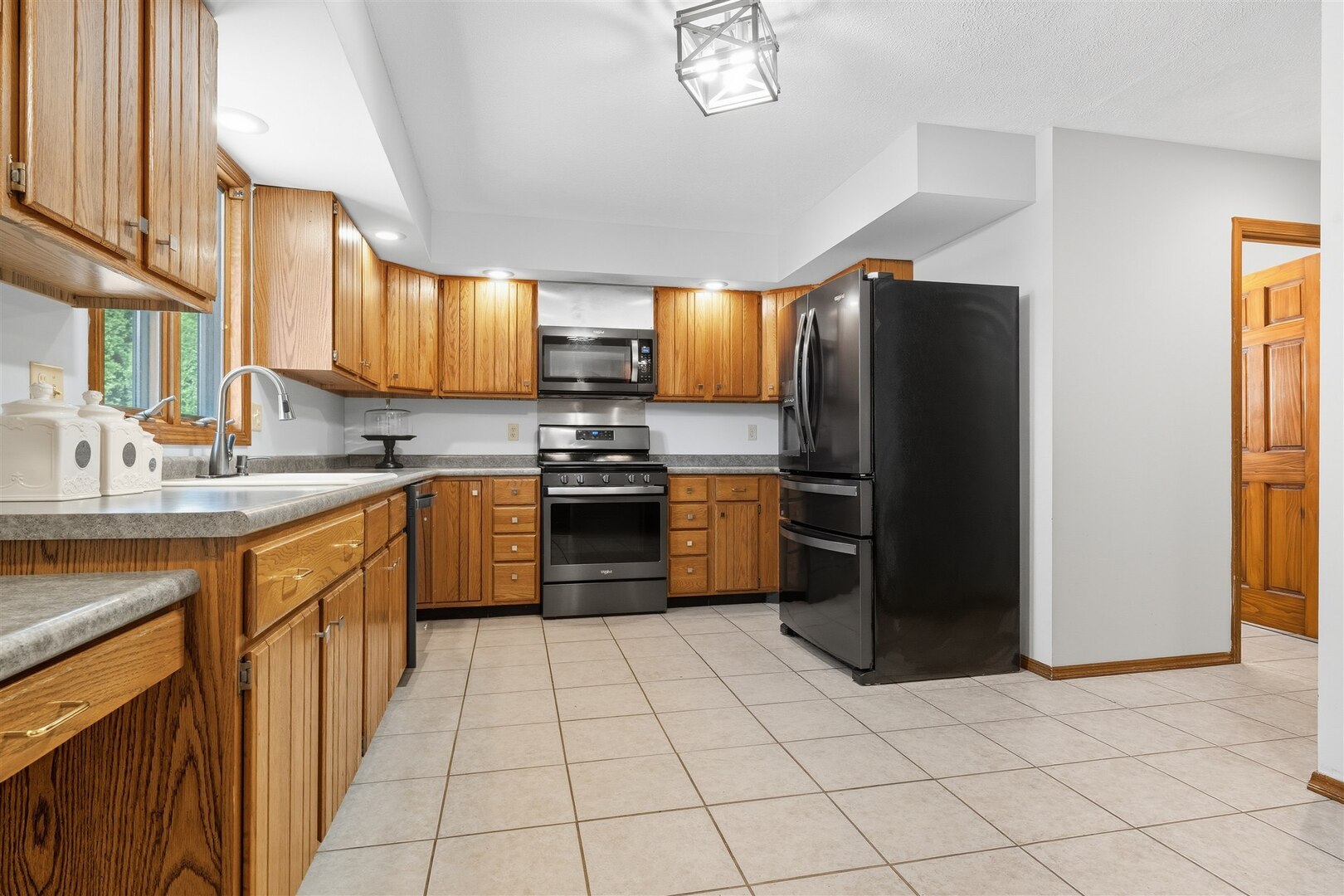 315 Garden Road Normal, IL 61761 - Photo 7 of 32 a kitchen with stainless steel appliances granite countertop a refrigerator a sink a stove top oven and cabinets