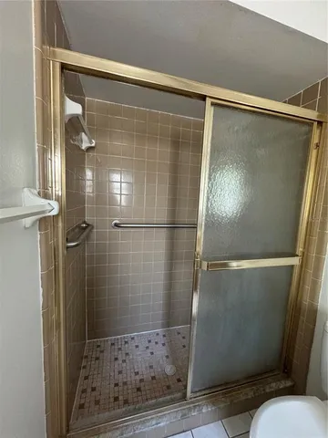 a bathroom with a glass shower door