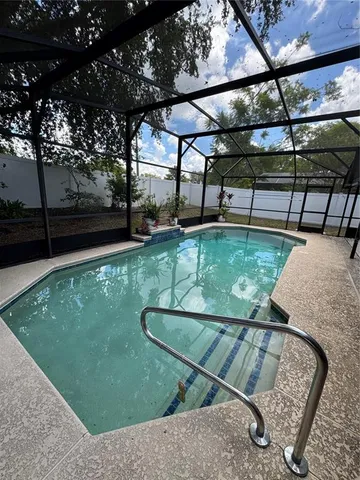 a view of a swimming pool with a patio