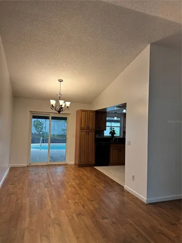 a view of a kitchen with a sink and a refrigerator