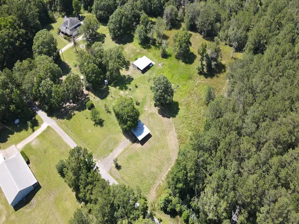 an aerial view of a house with a yard