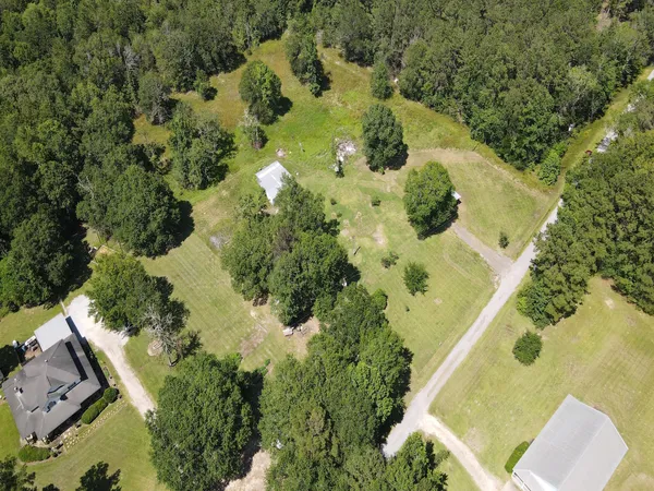 an aerial view of a house with a yard