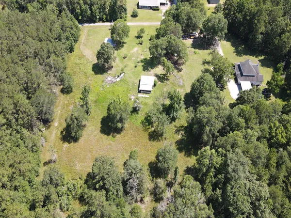 an aerial view of a house with a yard