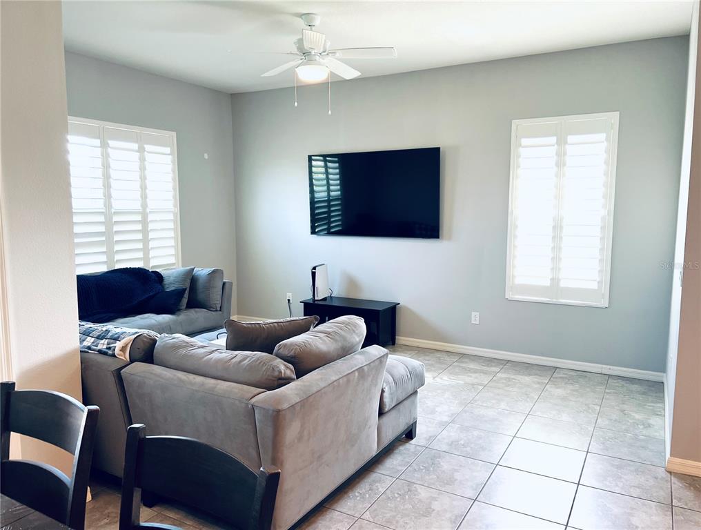 11124 Great Neck Road Riverview, FL 33578 - Photo 11 of 26 a living room with furniture a flat screen tv and a window