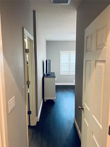 a view of a livingroom with wooden floor and a window