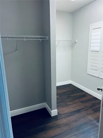 a view of a room with wooden floor