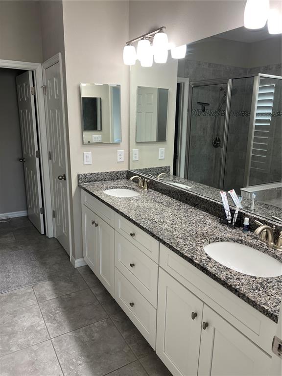 11124 Great Neck Road Riverview, FL 33578 - Photo 16 of 26 a bathroom with a granite countertop double sink and a mirror