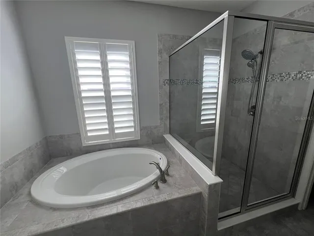 a bathroom with a bathtub and shower