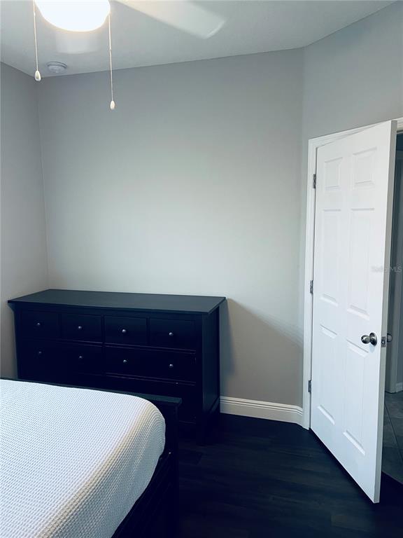 11124 Great Neck Road Riverview, FL 33578 - Photo 22 of 26 a room with a bed and a potted plant on dresser