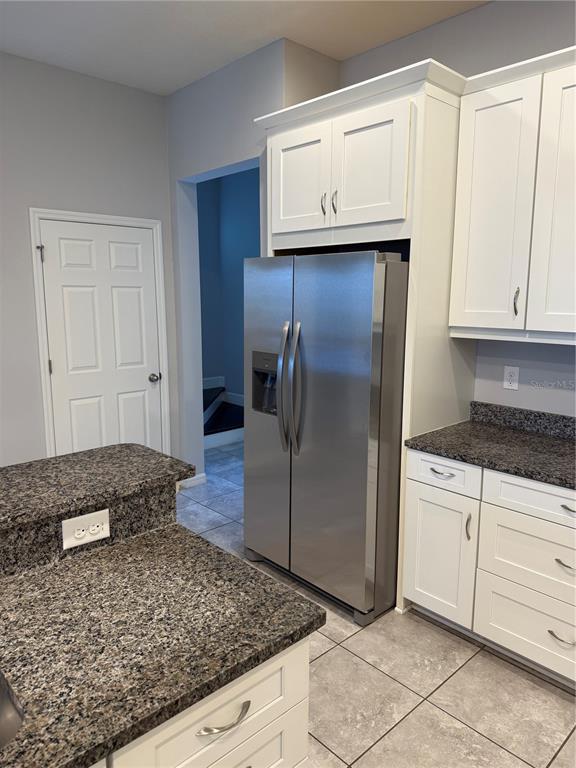 11124 Great Neck Road Riverview, FL 33578 - Photo 6 of 26 a kitchen with kitchen island granite countertop cabinets and refrigerator